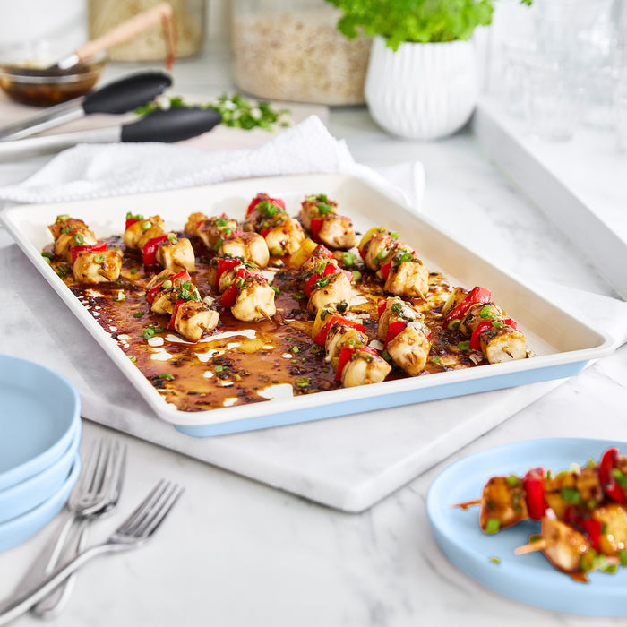 Chicken and veggie skewers with herbs on a blue GreenLife ceramic nonstick cookie sheet, 18x13.