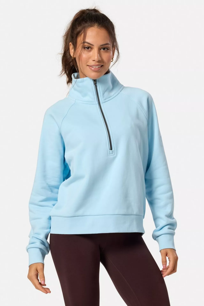 Woman wearing Gym+Coffee Clubhouse Quarter Zip in Baby Blue by Gym+Coffee, shop Gym+Coffee at Dotique for stylish activewear.