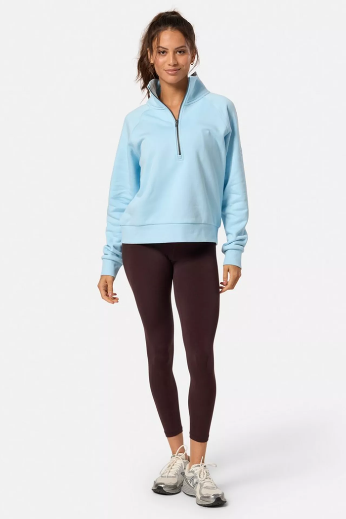 Model wearing Gym+Coffee Clubhouse Quarter Zip in Baby Blue from Gym+Coffee, shop Gym+Coffee at Dotique.