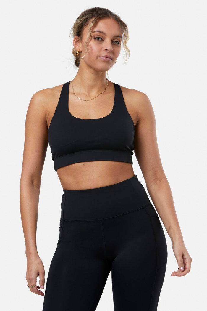 Woman wearing Gym+Coffee Relentless Bra Black by Gym+Coffee showcasing the fit, shop Gym+Coffee at Dotique.