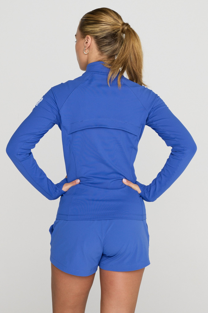 Model wearing Gym+Coffee Relentless Full Zip Tidal Blue jacket from Gym+Coffee, shop Gym+Coffee at Dotique.