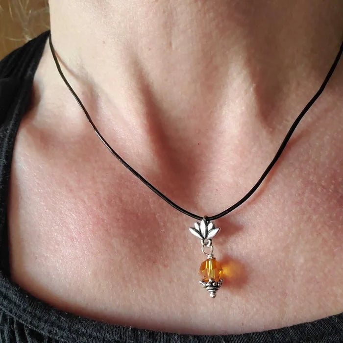 Handmade Silver Crystal Pineapple Leather Necklace worn with a black leather cord, featuring a silver pineapple charm and yellow crystal.