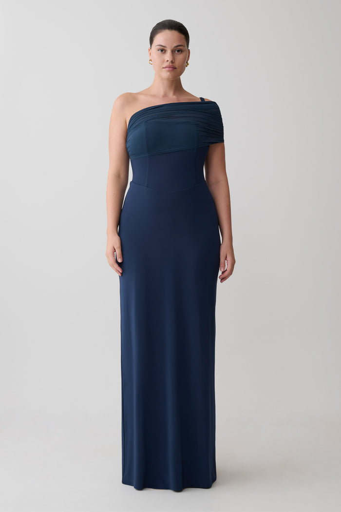 Woman wearing a navy one-shoulder gown.