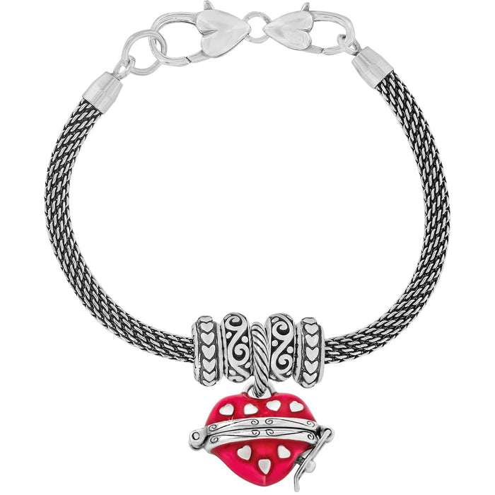 Brighton charm bracelet with silver-plated mesh chain, decorative bead stations, and red enamel heart charm on a white background