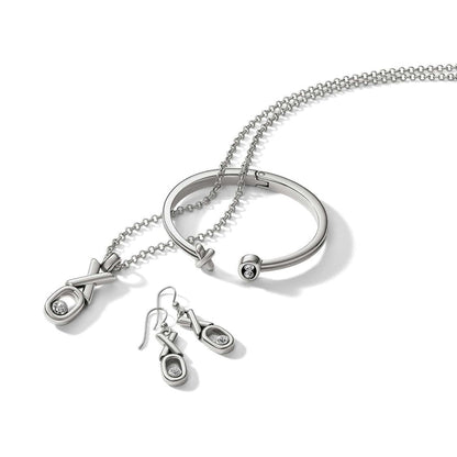 Brighton silver-plated jewelry set styled with XO motif necklace, drop earrings, and hinged bangle with crystal accents