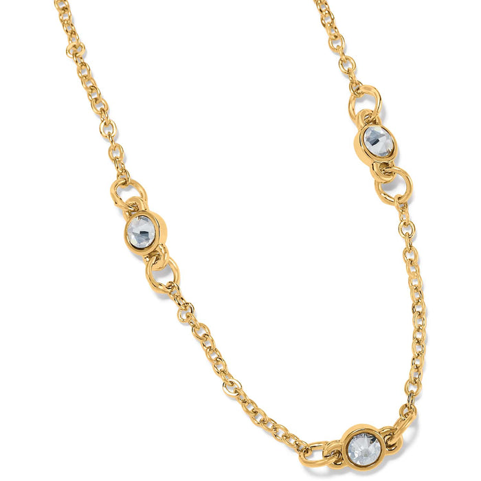 Brighton gold-plated chain necklace with three round crystal stations in bezel settings on a white background