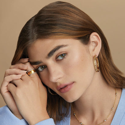 Model wearing Brighton gold-plated hoop earrings with hammered texture and coordinating Brighton ring and necklace accessories