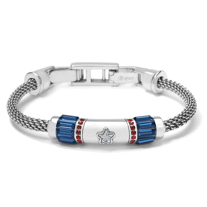 Brighton bracelet with silver-plated mesh band, blue baguette crystals, red crystal accents, and central star motif on a white background