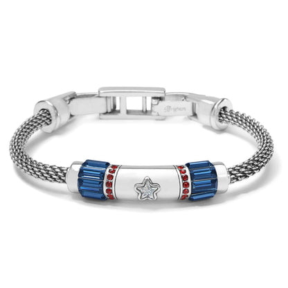 Brighton silver-plated bracelet with mesh chain, blue baguette crystals, red crystal accents, and central star on a white background