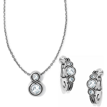 Brighton necklace and hoop earrings set with silver-tone swirl design and crystal accents on a white background