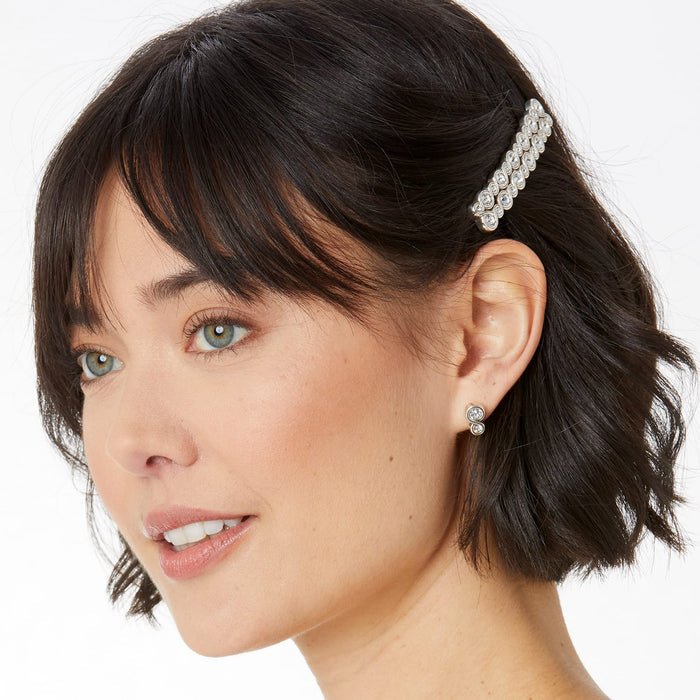 Model wearing a Brighton silver-plated hair barrette with crystal accents paired with matching crystal stud earrings