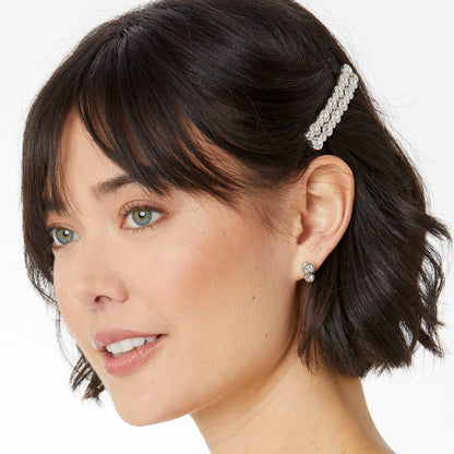 Model wearing a Brighton silver-plated hair barrette with crystal accents paired with matching crystal stud earrings