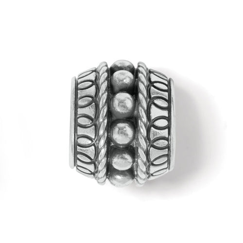 Brighton silver-plated barrel bead charm with beaded center row and rope and oval patterned borders on a white background