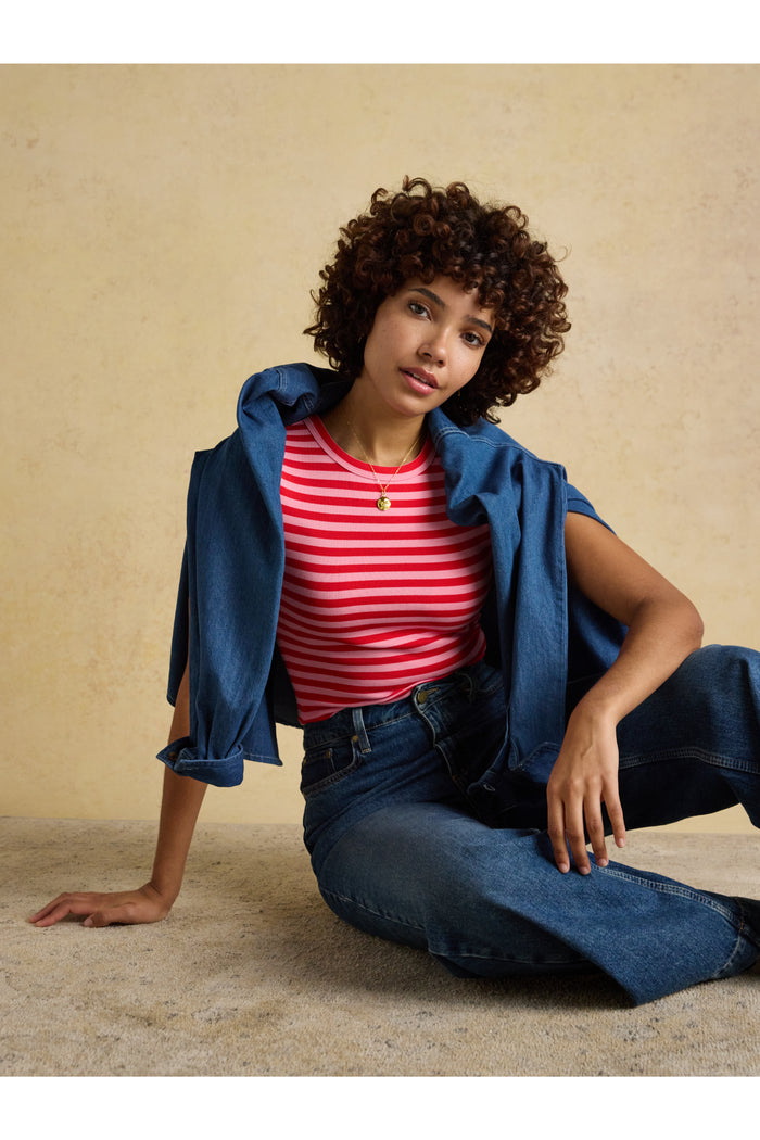 Woman wearing Joules H18088 Sophie Ribbed T-Shirt – Pink / Red Stripe with denim jacket, shop Joules at Dotique fashion retailer.