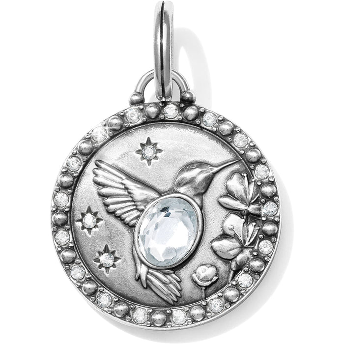 Brighton silver-plated charm pendant with hummingbird, flowers, stars, central crystal, and pave crystal border on a white background