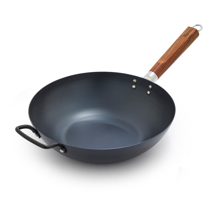 Black wok with a wooden handle on a white background