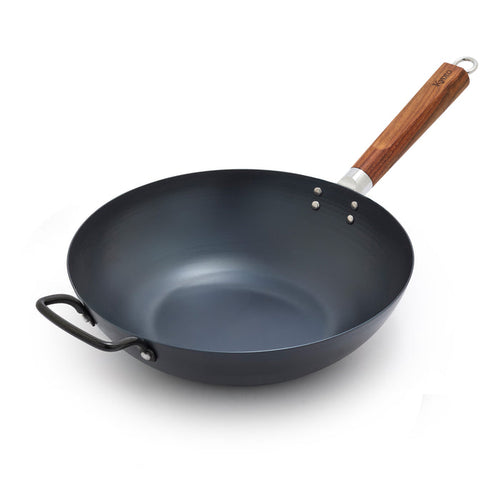 Black wok with a wooden handle on a white background
