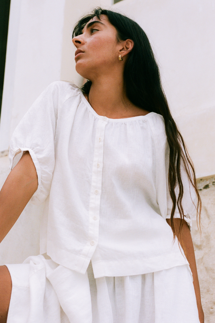 Woman wearing Lilly Pilly LP-T008 Pia Linen Top Ivory by Lilly Pilly, shop the brand at Dotique for stylish linen wear.