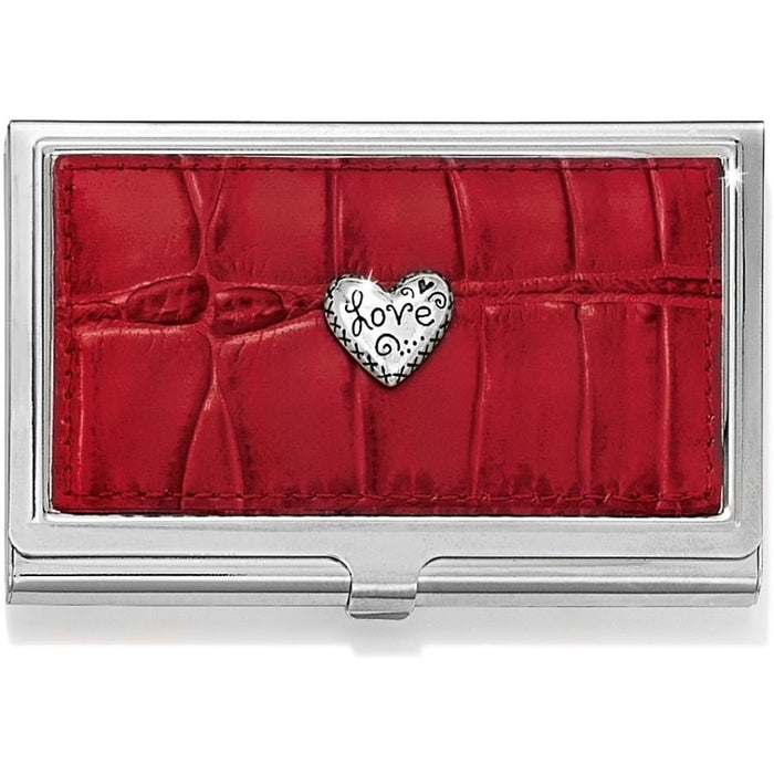 Brighton business card case with red croc-embossed leather panel and silver-tone heart love medallion on a white background