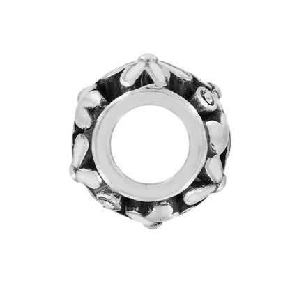 Brighton silver-tone charm bead with white enamel floral pattern and crystal accents on a white background