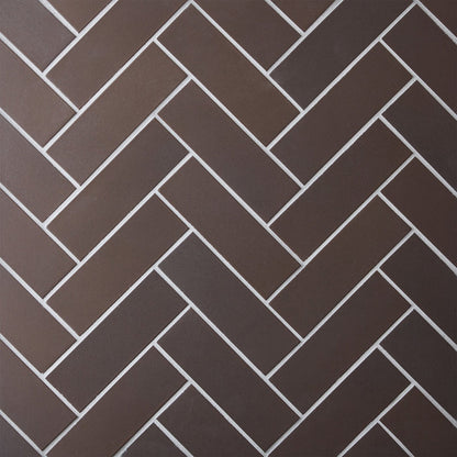 Caption: Classic Field 2x6 in M39.2 Matte Brown. Prism Winter Grey grout by Custom Building Products.