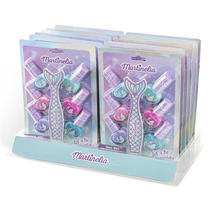 A display stand holds multiple Martinelia Let's Be Mermaids Nails Sets, featuring pastel pink, purple, and blue kids nail polishes and the phrase "let's be mermaids" on each set.