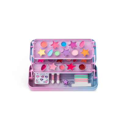The Martinelia Little Unicorn Makeup Tin Case by Martinelia includes star-shaped eyeshadows, round blushes, applicators, stickers, and small makeup accessories, all neatly arranged in a vibrant pink and blue plastic case.