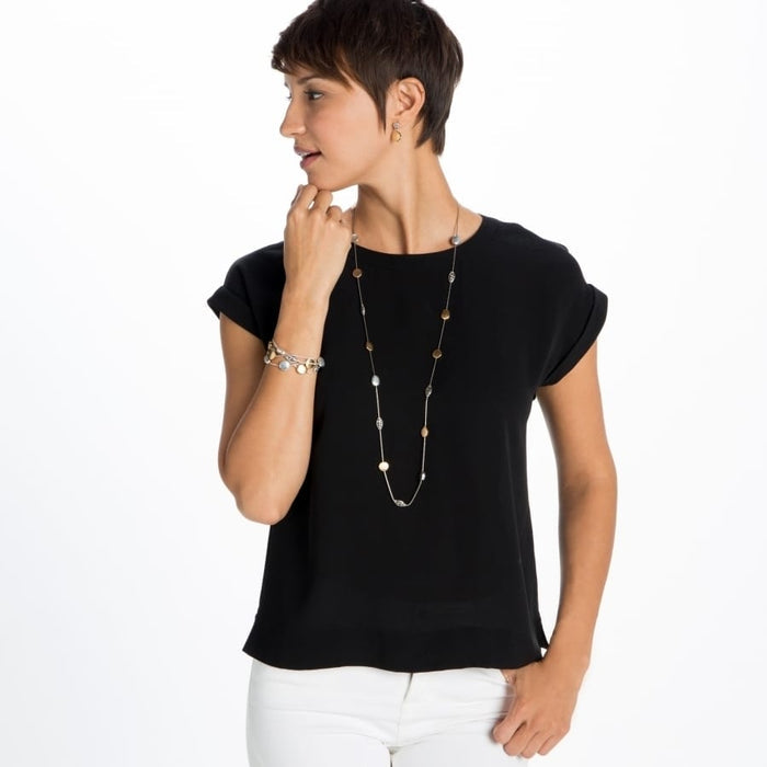 Model wearing a long Brighton necklace with hammered silver and gold plated discs paired with a coordinating bracelet
