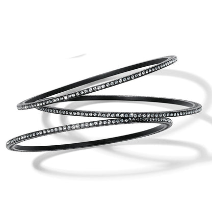 Brighton bangle bracelets with black lacquer finish and pavé crystal detailing, three stacked together on a white background