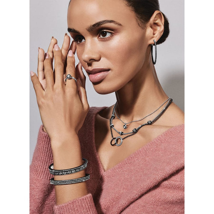 Model wearing a Brighton crystal hoop earring with coordinating Brighton necklaces, bracelets, and ring accessories