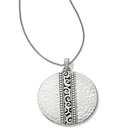 Brighton pendant necklace with hammered silver-plated disc and ornate scroll bead center band on a white background