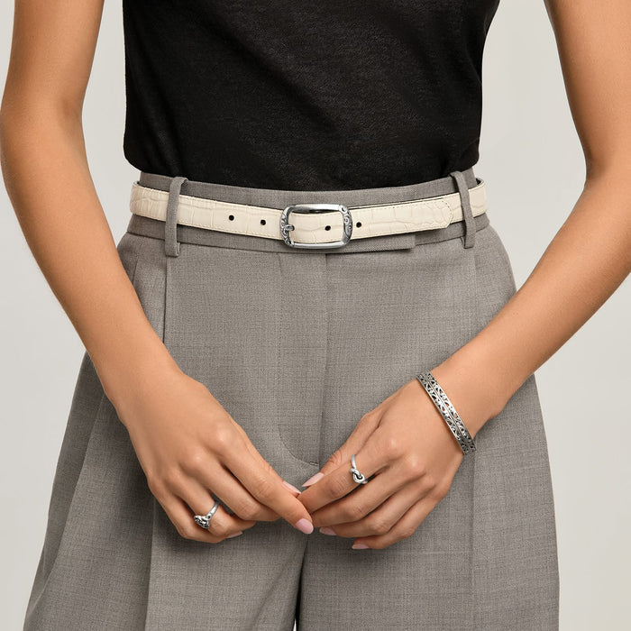Model wearing a Brighton cream croc-embossed leather belt with ornate silver-tone scroll buckle and coordinating Brighton accessories