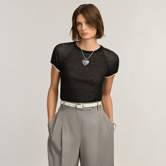 Model wearing a Brighton silver heart pendant necklace on a snake chain with ornate scrollwork design