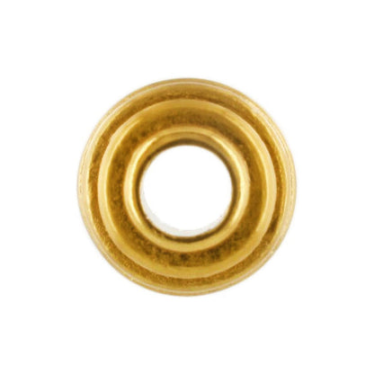 Brighton bead with gold-tone finish and ridged concentric rings around a central opening on a white background
