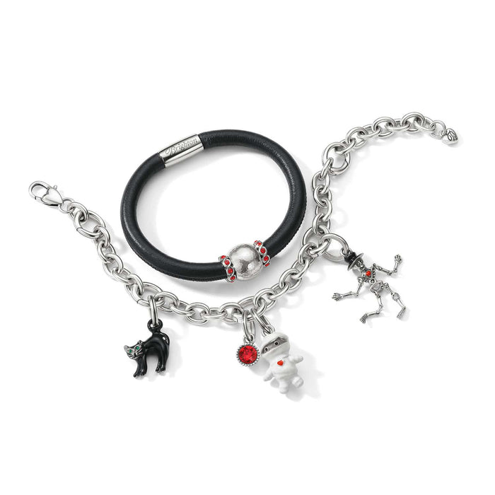 Brighton bracelets styled with Halloween enamel charms including black cat, mummy, and skeleton on a white background