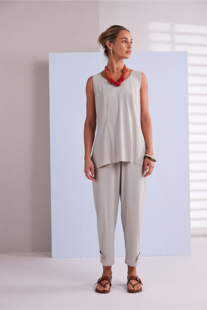 Model wearing Naya NPA26179 Slim Leg Trouser With Tab At Hem Ash paired with a sleeveless top and red statement necklace, shop Naya at Dotique.