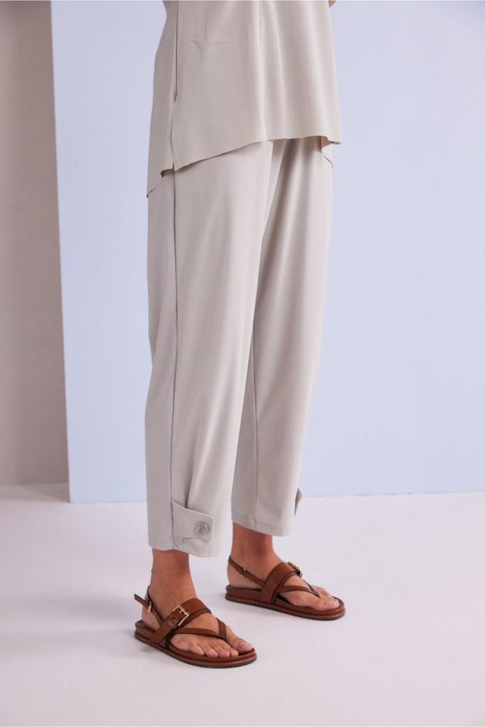 Naya NPA26179 Slim Leg Trouser With Tab At Hem Ash in light ash color worn with brown sandals, shop Naya at Dotique.