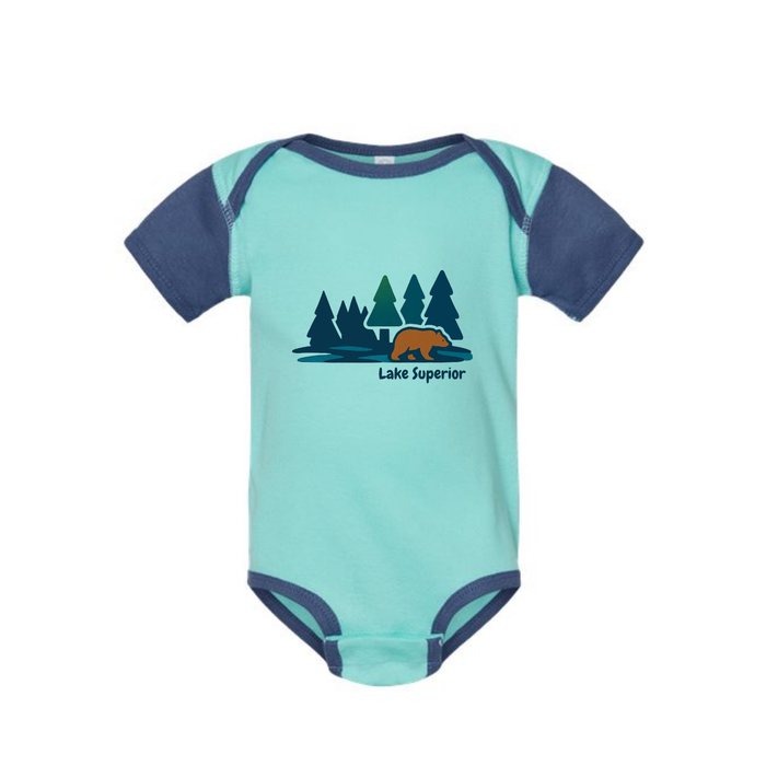 AdventureUs Lake Superior graphic featuring a bear in the woods on a two tone blue baby bodysuit.