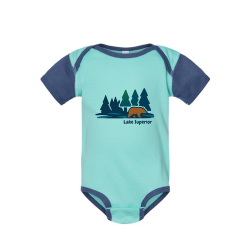 AdventureUs Lake Superior graphic featuring a bear in the woods on a two tone blue baby bodysuit.