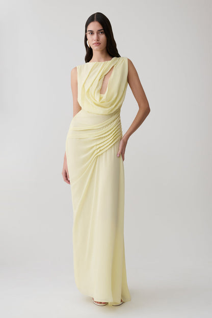 Woman wearing a light yellow chiffon maxi dress.