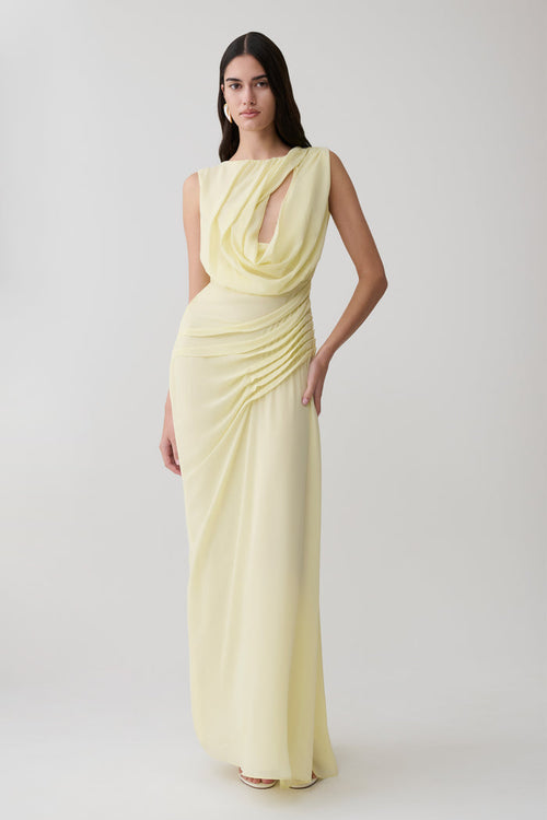 Woman wearing a light yellow chiffon maxi dress.