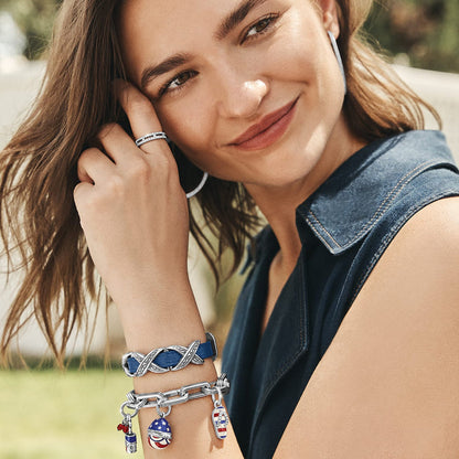Model wearing a Brighton silver-tone link bracelet with patriotic enamel charms and coordinating Brighton accessories