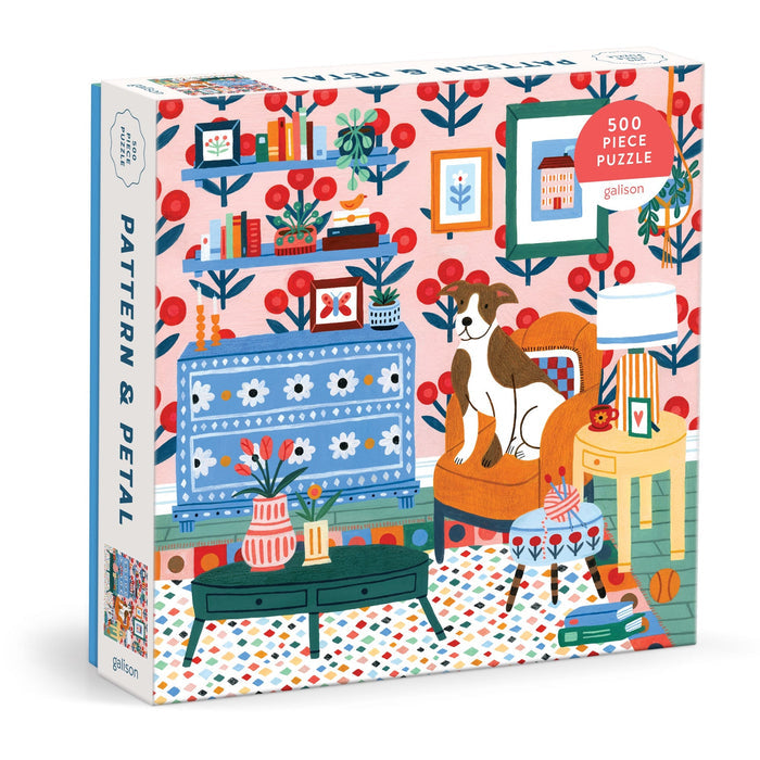 The Pattern & Petal 500 Piece Puzzle by Molly Egan features an illustrated living room with bold patterns, a dog on an armchair, plants, bookshelves, and vibrant decor in reds, blues, and greens.