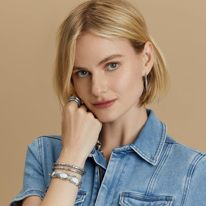 Model wearing Brighton silver-plated hoop earrings with textured bracelets and ring, styled with coordinating Brighton accessories