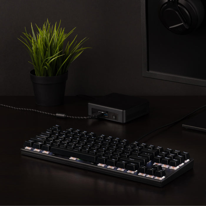 Plugable USB-MECH87RW tenkeyless mechanical keyboard connected to a computer via USB cable on a desk.