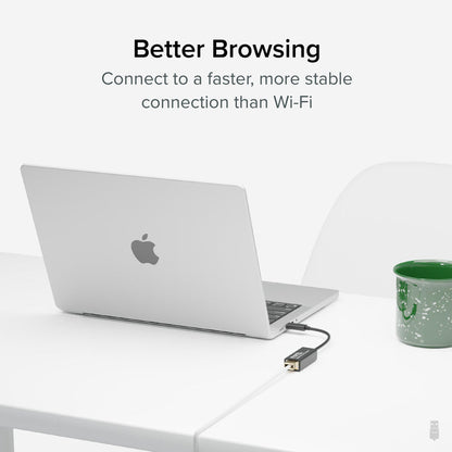 Plugable USBC-E1000 USB-C to Gigabit Ethernet adapter connected to a laptop for a stable wired network connection.