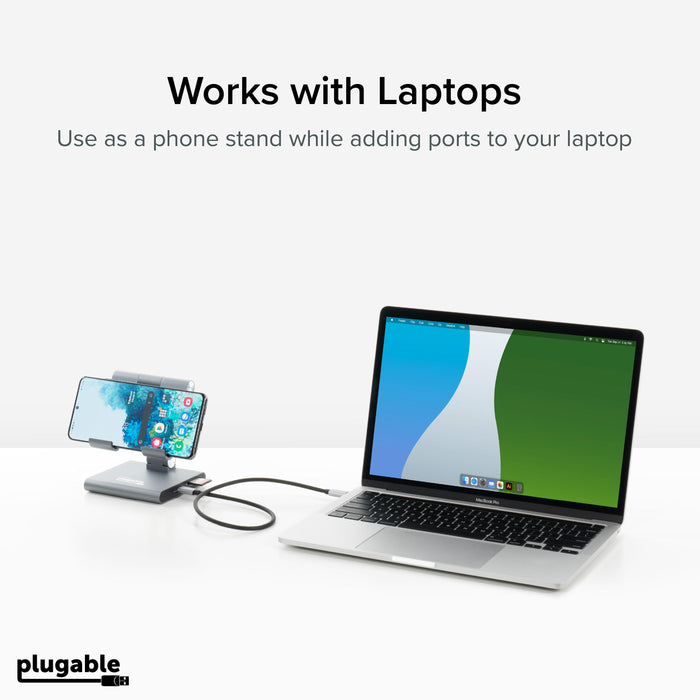 Plugable UDS-7IN1 hub functioning as a phone stand while connected to a laptop via USB-C.