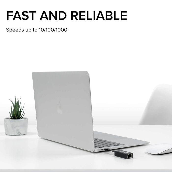 Plugable USBC-TE1000 Ethernet adapter connected to a laptop, supporting network speeds up to 10/100/1000 Mbps.