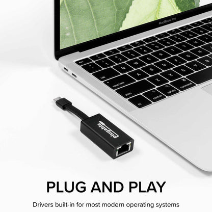 Plugable USB-C to Ethernet adapter connected to a MacBook Pro, featuring plug-and-play functionality with built-in drivers.