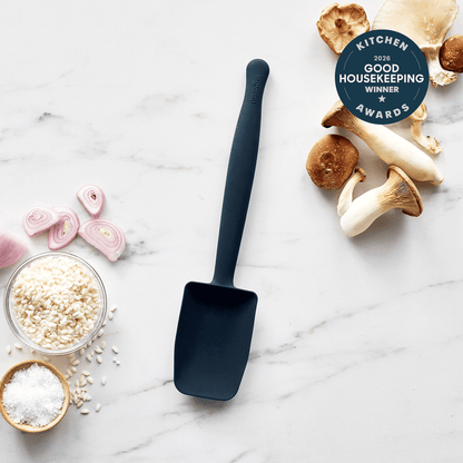 Blue silicone sauté spoon on marble, surrounded by mushrooms, shallots, rice, salt, and a 2023 award badge.